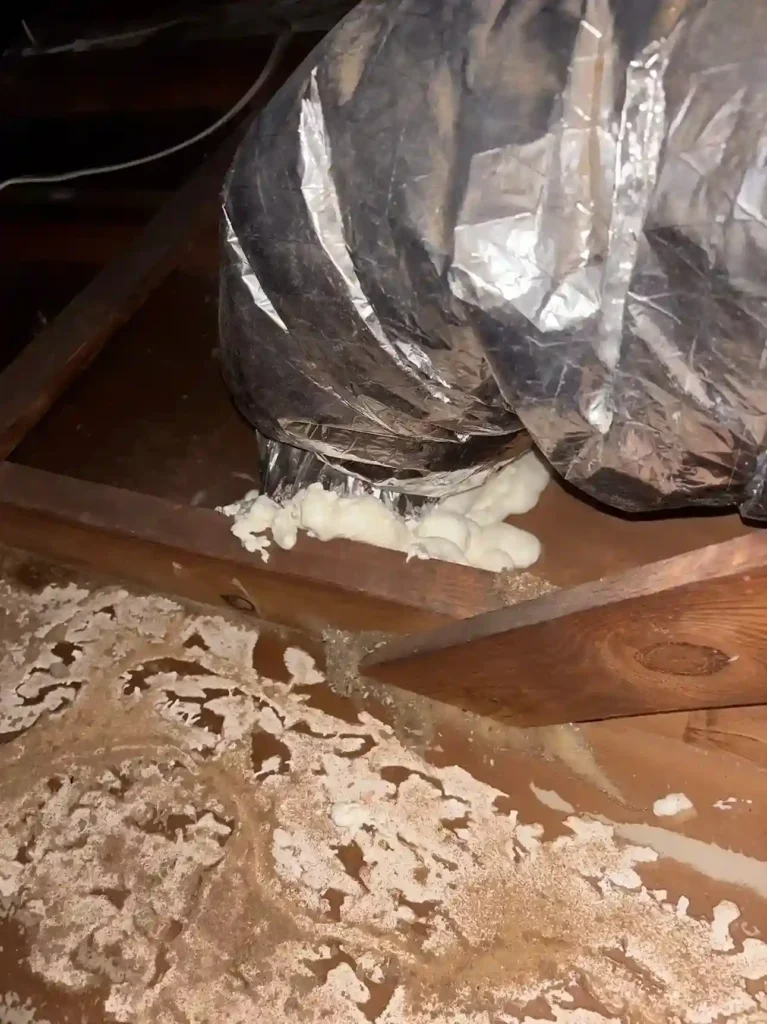 HVAC ductwork boot connection sealed with spray foam at attic floor for air sealing by Level Home Pros in Virginia Beach
