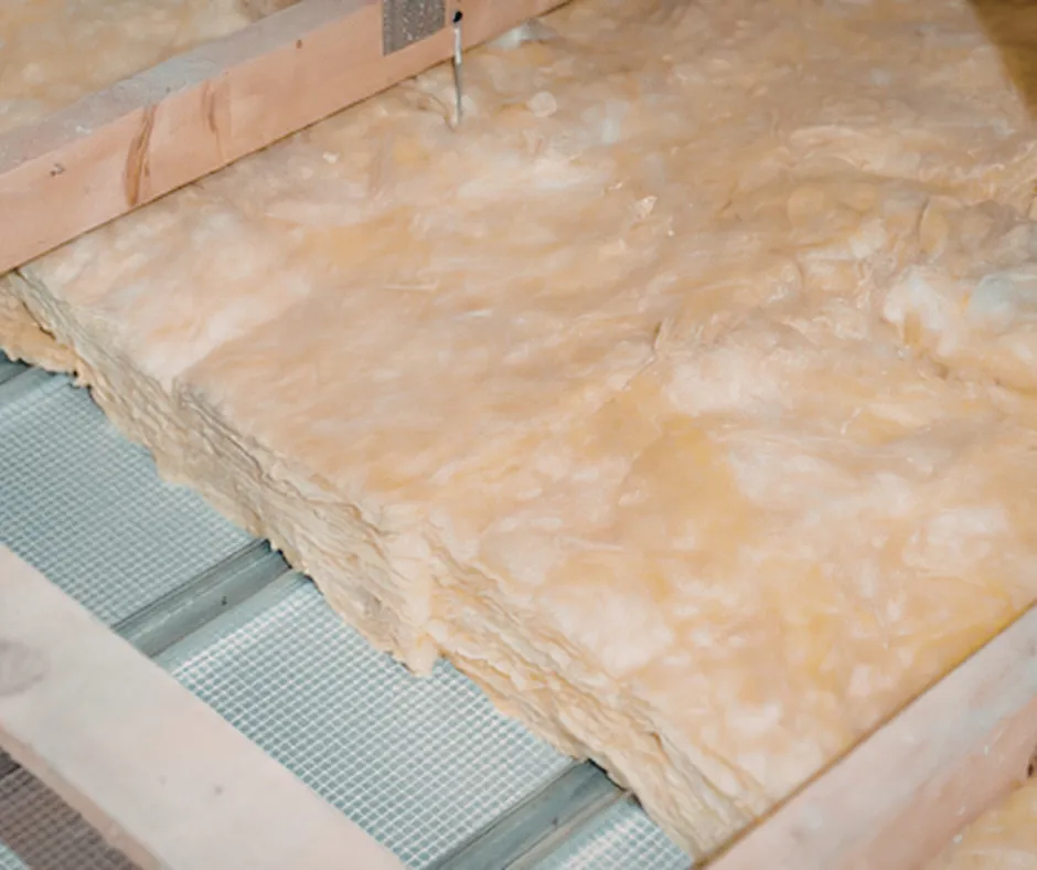 Fiberglass batt insulation installed over floor joists with mesh backing for thermal performance by Level Home Pros in Norfolk VA